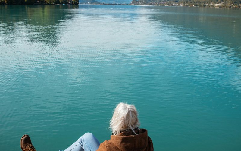 Woman at peaceful mountain lake